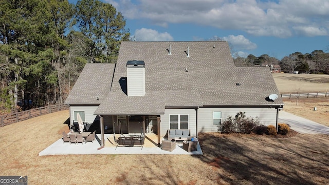 back of house featuring a patio area, a yard, and an outdoor hangout area