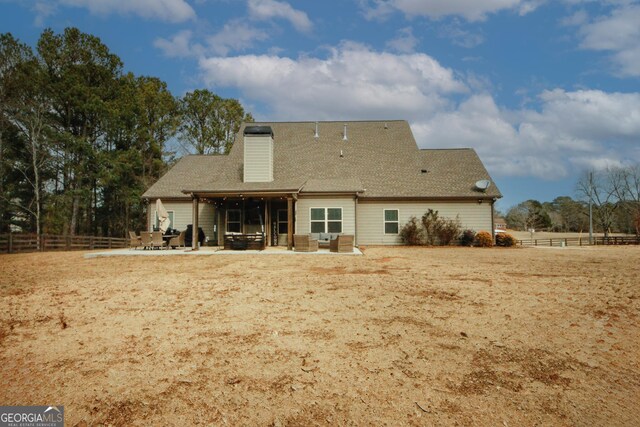 rear view of house with outdoor lounge area and a patio area