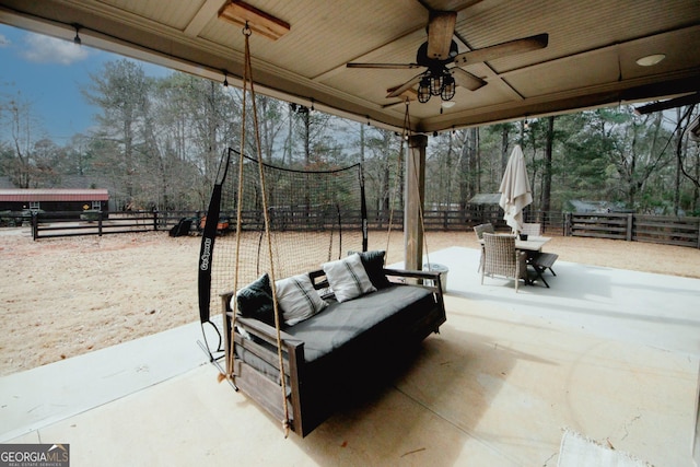 living room with ceiling fan, ornamental molding, a fireplace, and a wealth of natural light