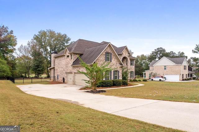 view of front of property featuring a garage and a front yard