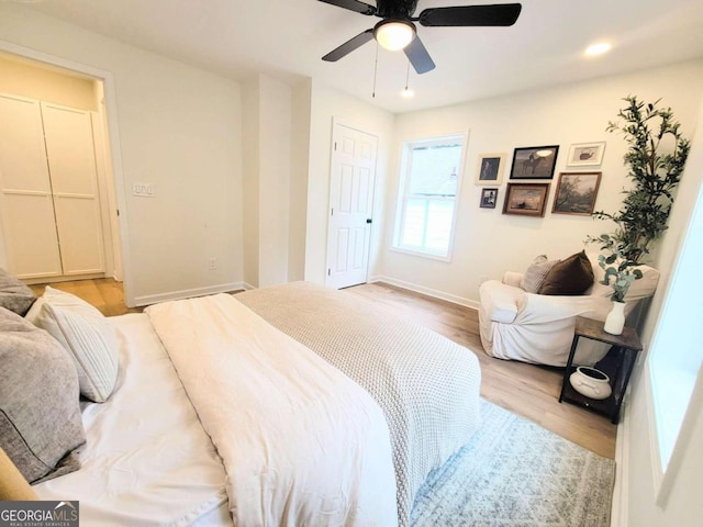 bedroom featuring light hardwood / wood-style floors and ceiling fan