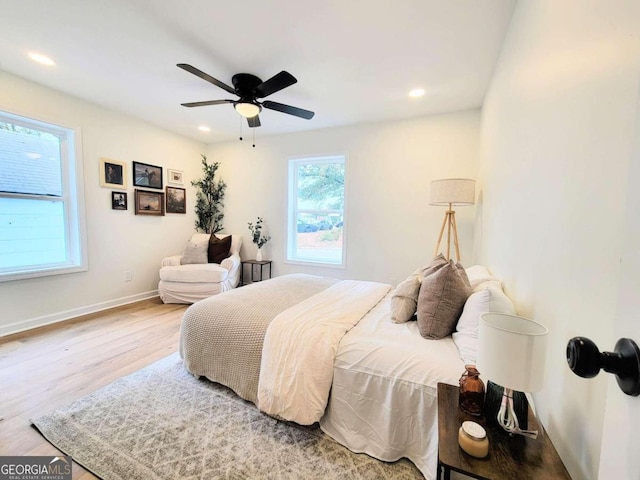 bedroom with ceiling fan and light hardwood / wood-style flooring