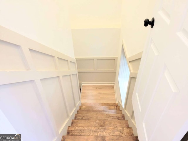 staircase with hardwood / wood-style floors