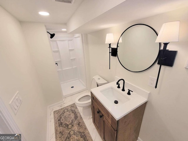 bathroom featuring a shower, vanity, and toilet