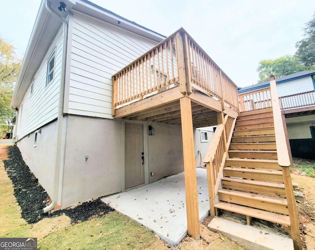 rear view of property with a patio and a deck