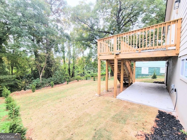 view of yard with a patio area and a wooden deck