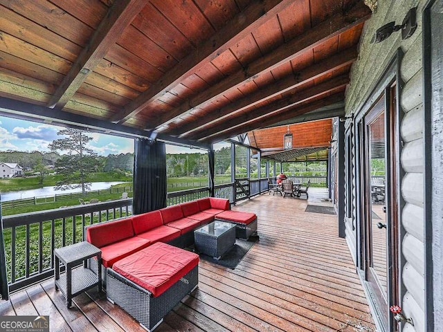 wooden deck with an outdoor hangout area and a water view