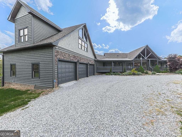 42 Lone Pine Dr, Morganton, GA 30560 - view of side of home featuring gravel driveway, a garage, and a shingled roof