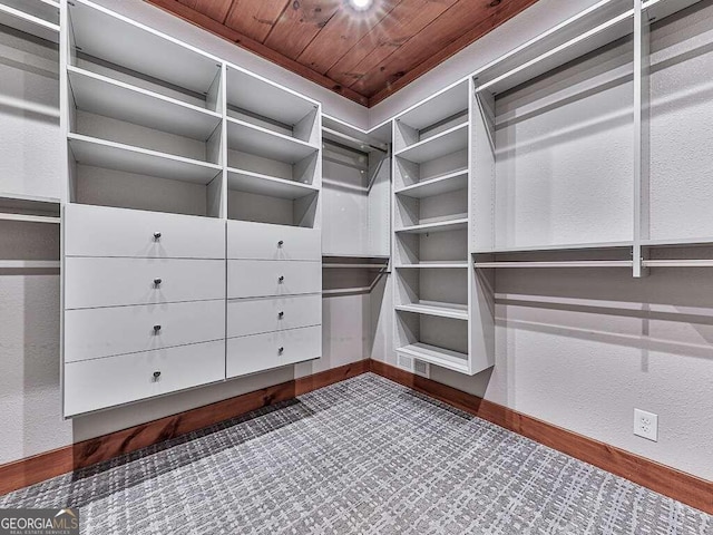 walk in closet with dark hardwood / wood-style flooring