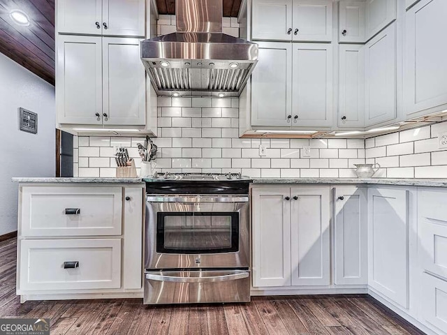 kitchen featuring white cabinetry, stainless steel electric range oven, dark hardwood / wood-style floors, and wall chimney range hood