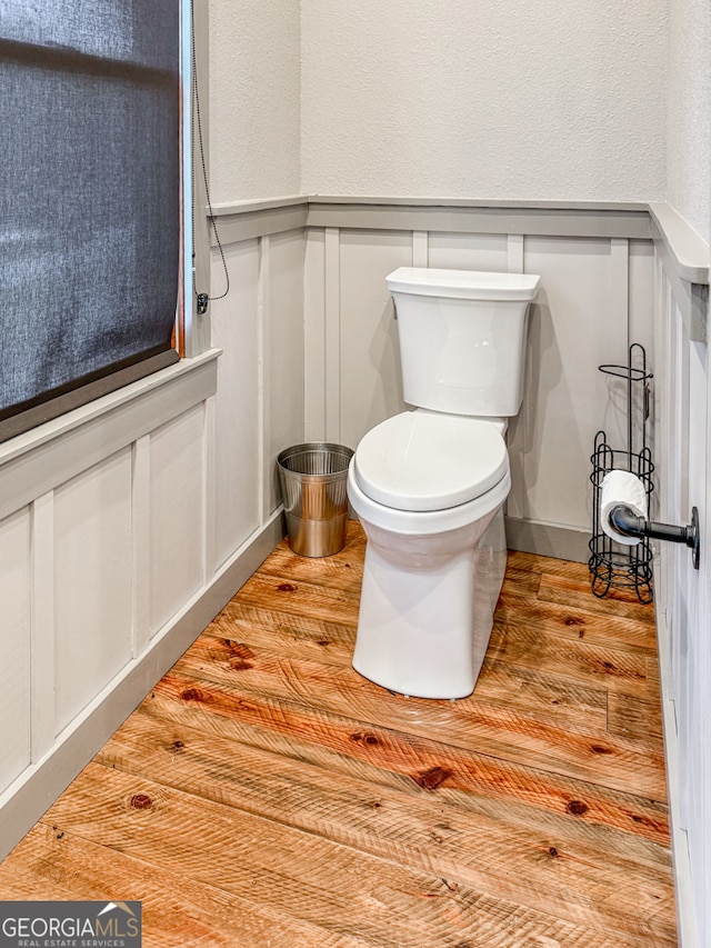 bathroom with toilet and wood-type flooring