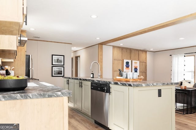 kitchen with light wood-type flooring, a center island with sink, and stainless steel appliances