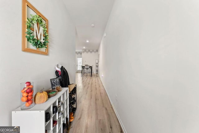 hallway with light hardwood / wood-style flooring