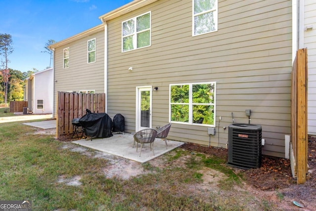 rear view of house featuring cooling unit and a patio