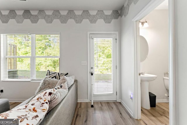 entryway with light hardwood / wood-style flooring and sink