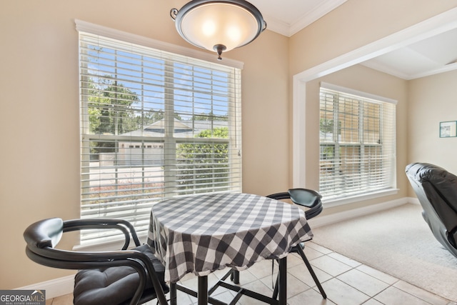 dining area with light colored carpet and crown molding