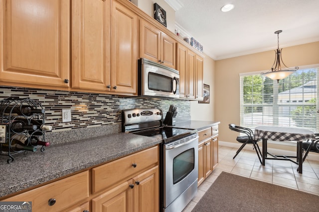 kitchen featuring light tile patterned flooring, appliances with stainless steel finishes, decorative light fixtures, crown molding, and decorative backsplash