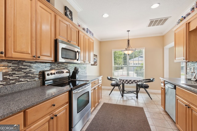 kitchen with light tile patterned floors, tasteful backsplash, crown molding, pendant lighting, and appliances with stainless steel finishes