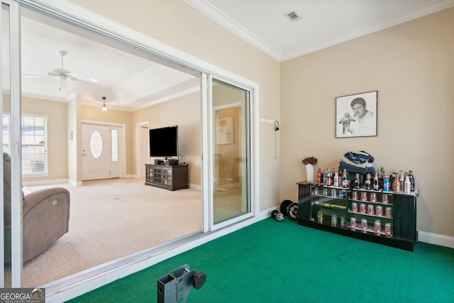 playroom with ceiling fan, crown molding, and carpet