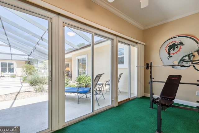 doorway with ceiling fan, crown molding, and carpet floors