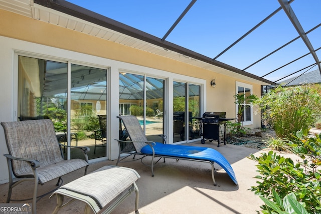 view of patio / terrace with glass enclosure and area for grilling