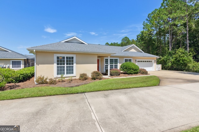 ranch-style house featuring a front lawn and a garage