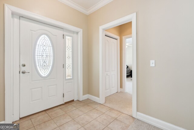 tiled foyer with ornamental molding