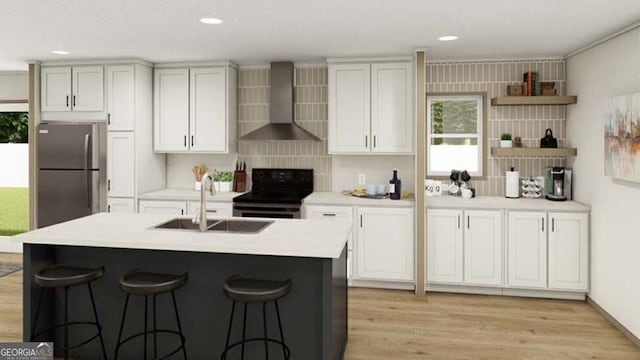 646 Grande Ave, Folkston, GA 31537 - kitchen with wall chimney range hood, black range with electric stovetop, freestanding refrigerator, a sink, and a kitchen breakfast bar