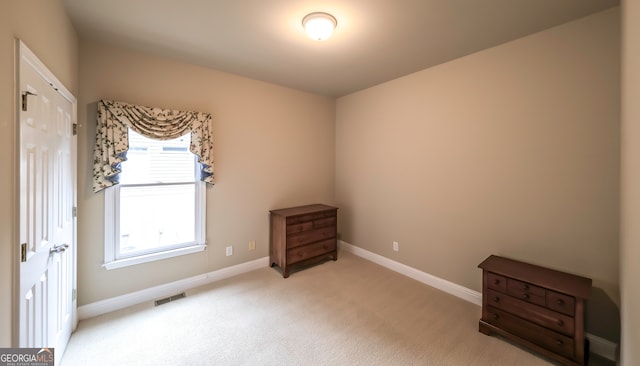 unfurnished bedroom with light colored carpet