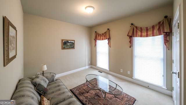 carpeted living room featuring a healthy amount of sunlight