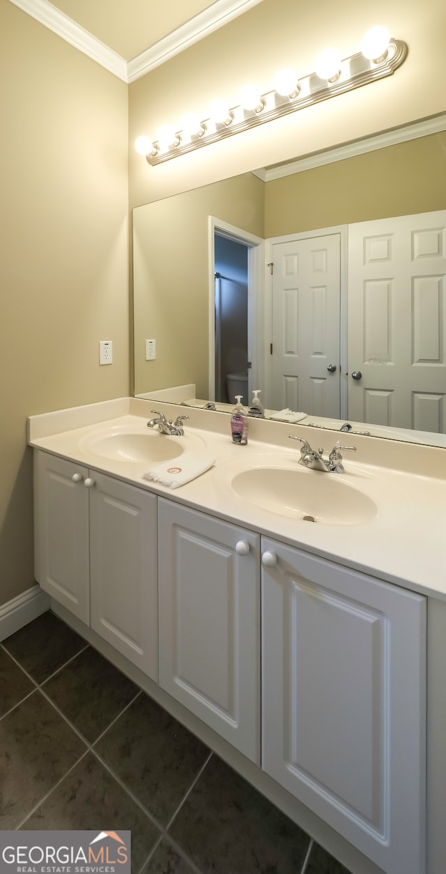 bathroom featuring tile patterned flooring, vanity, and crown molding