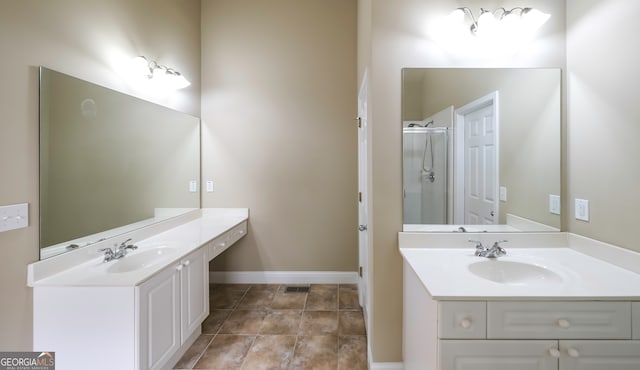 bathroom featuring tile patterned floors, vanity, and a shower with shower door