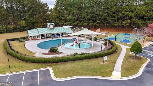 view of swimming pool with a yard