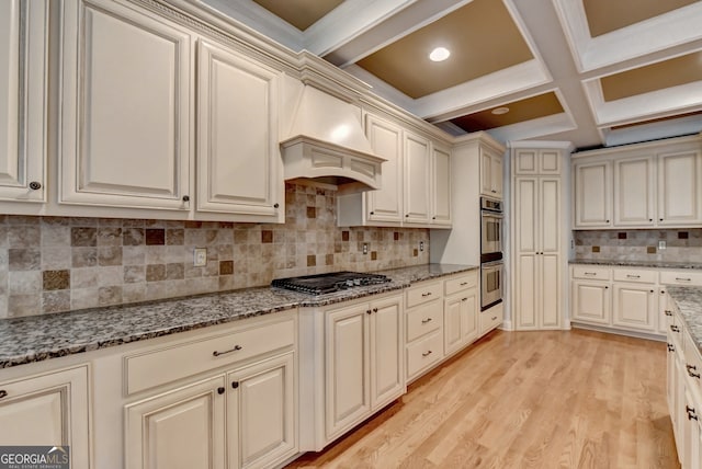 kitchen with light hardwood / wood-style floors, coffered ceiling, beamed ceiling, backsplash, and premium range hood