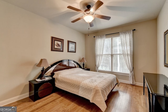 bedroom with light hardwood / wood-style floors and ceiling fan