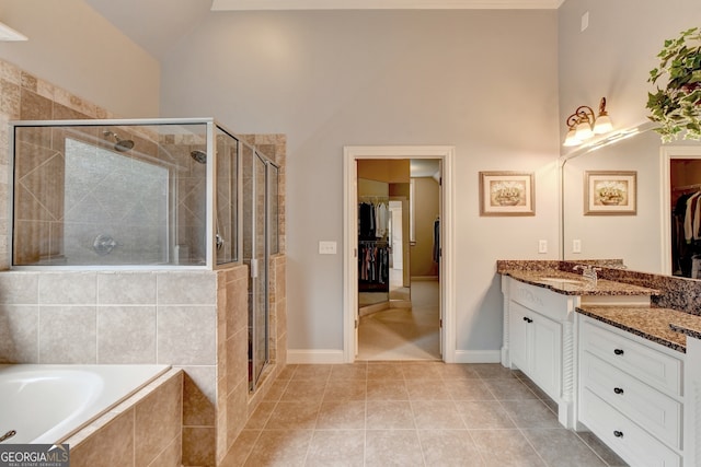 bathroom featuring tile patterned flooring, vanity, separate shower and tub, and high vaulted ceiling