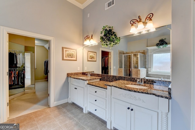 bathroom with vanity, tile patterned floors, ornamental molding, and a shower with shower door