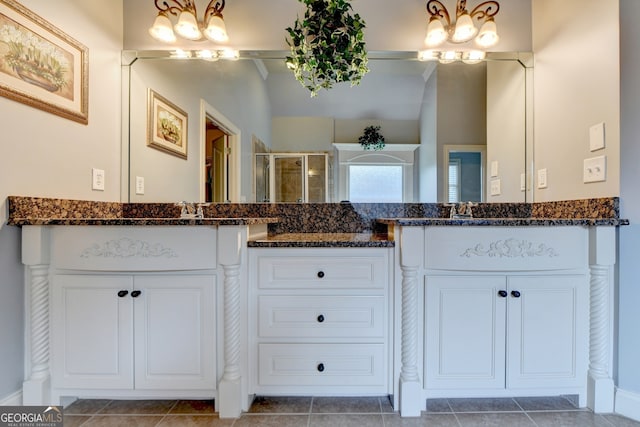 bathroom featuring vanity, a shower with door, and tile patterned flooring