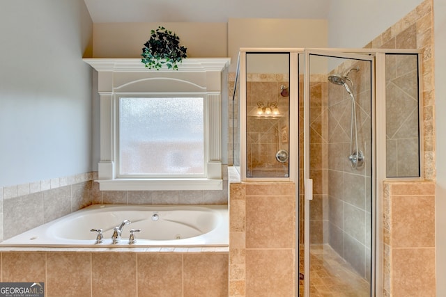 bathroom featuring independent shower and bath