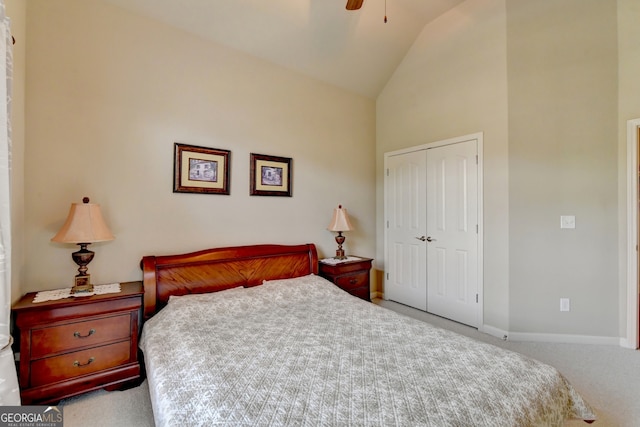 carpeted bedroom with high vaulted ceiling, ceiling fan, and a closet