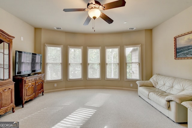 carpeted living room featuring ceiling fan