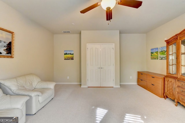 sitting room with light carpet and ceiling fan