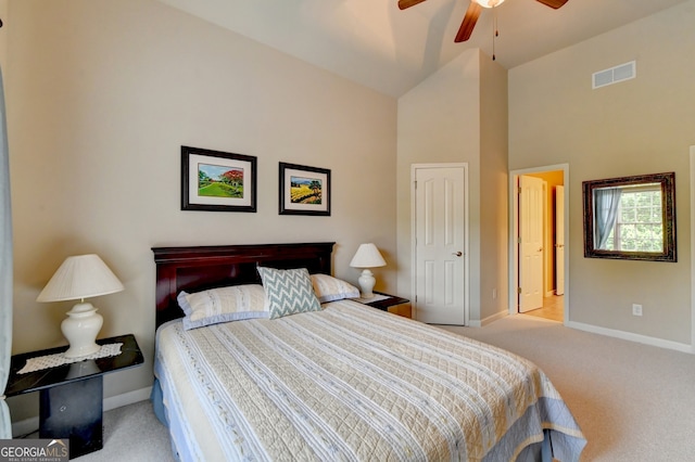 carpeted bedroom with high vaulted ceiling and ceiling fan