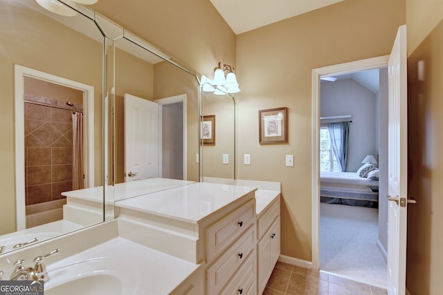 bathroom with vanity, tile patterned flooring, curtained shower, and vaulted ceiling