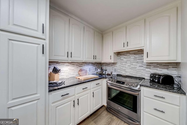 kitchen featuring white cabinetry, dark stone countertops, and stainless steel electric range