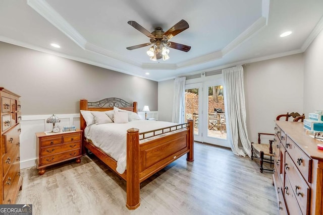 bedroom with a raised ceiling, access to exterior, ceiling fan, and light hardwood / wood-style flooring