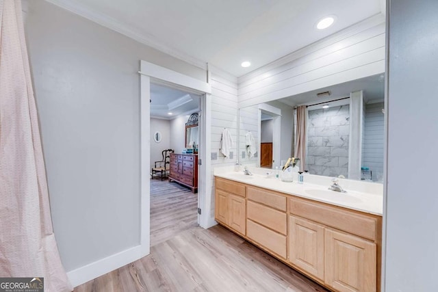 bathroom featuring vanity, hardwood / wood-style flooring, and ornamental molding