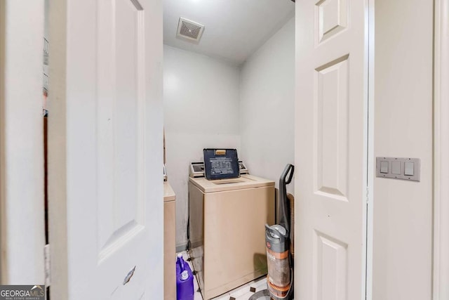 laundry area with washing machine and dryer