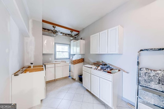 kitchen featuring light tile patterned floors, white cabinetry, and ceiling fan