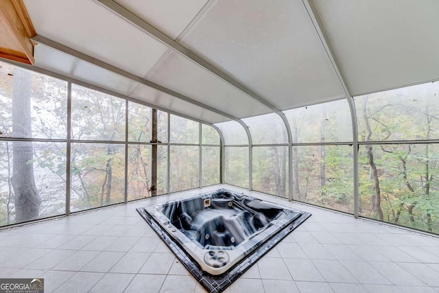 sunroom with a wealth of natural light and a hot tub